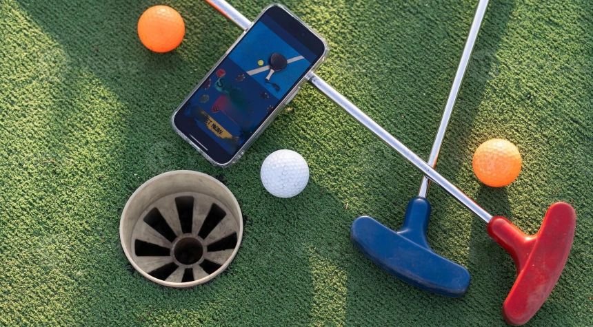 golf clubs and balls and smartphone